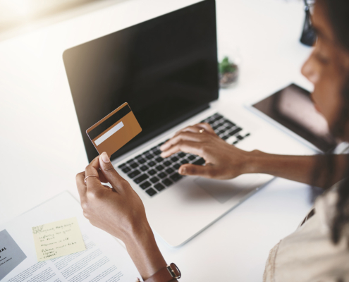 Woman Looking At Card For Online Payment